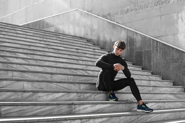 Человек в спортивной одежде на лестнице на открытом воздухе