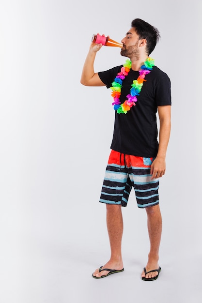 Man in beachwear drinking