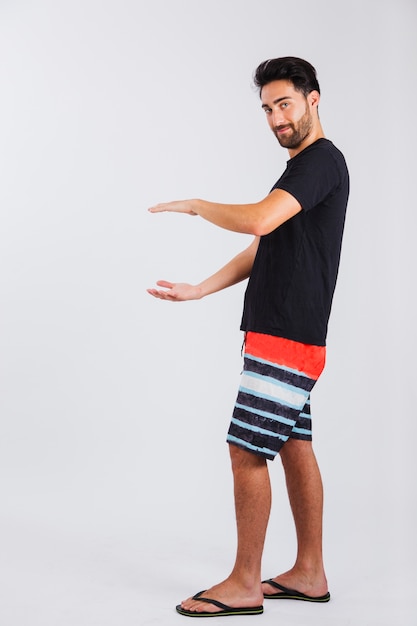 Man in beachwear showing size