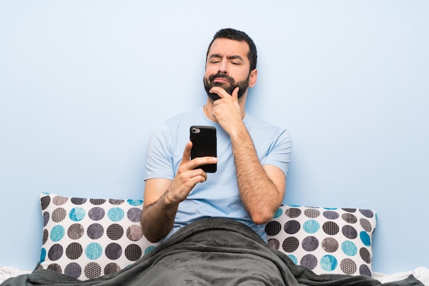 Man in bed thinking | Photo: Pexels