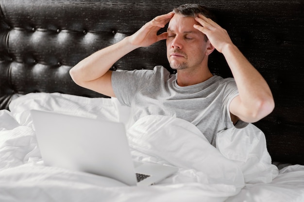 Man in bed using laptop