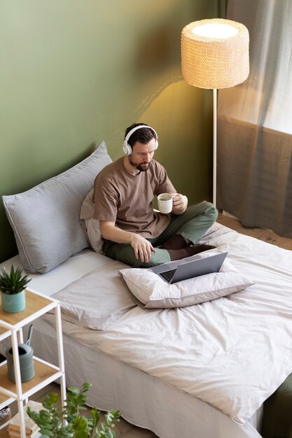 Man on bed watching video