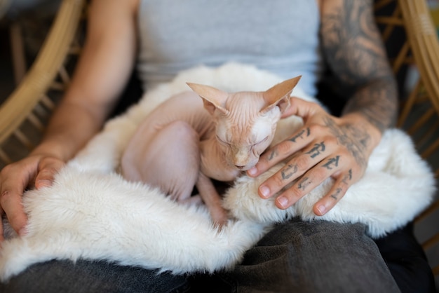 Man being affectionate with cat front view