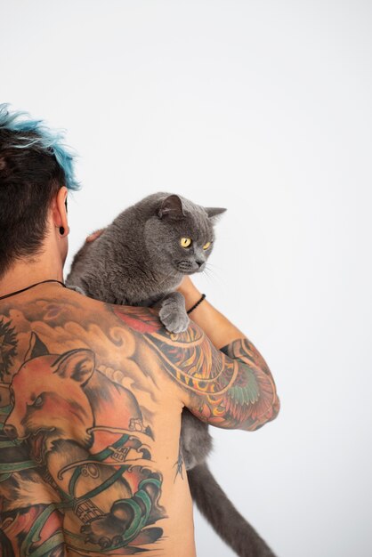 Man being affectionate with cute cat back view