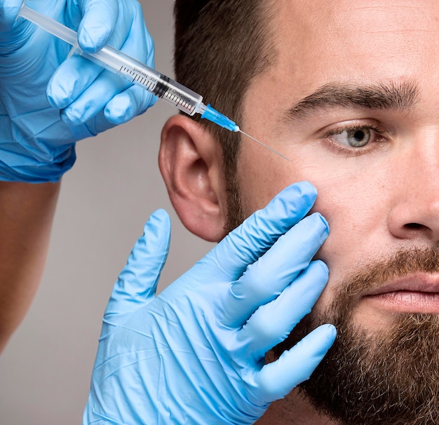 Man being injected in his face