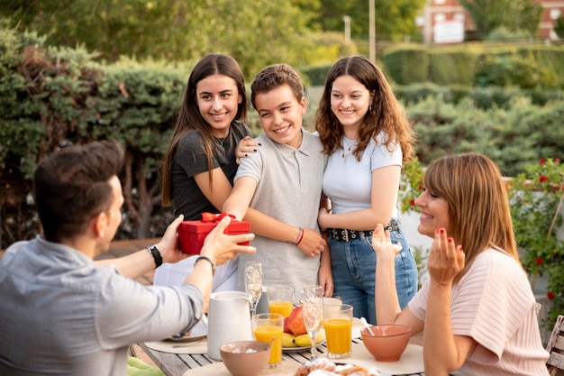 Man being surprised with gift at family gathering