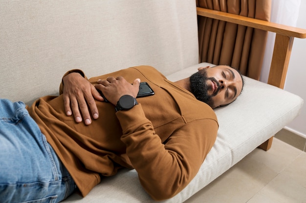 Man being tired after spending too much time on his phone