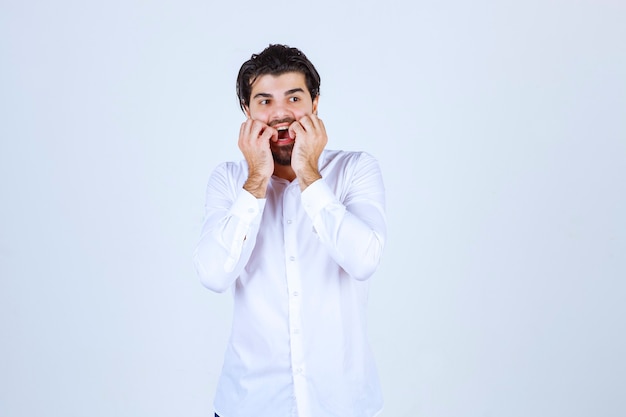 Man biting his nails as he is scared