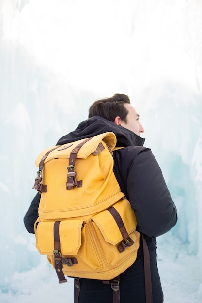 Man in black jacket and brown backpack