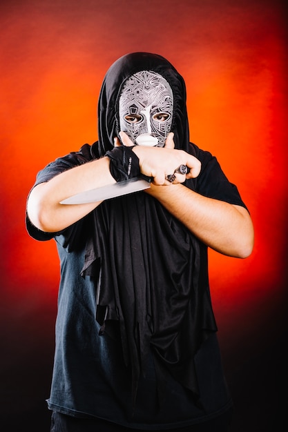 Man in black posing with knife