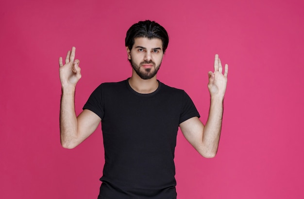 Man in black shirt feels positive about something and enjoys it