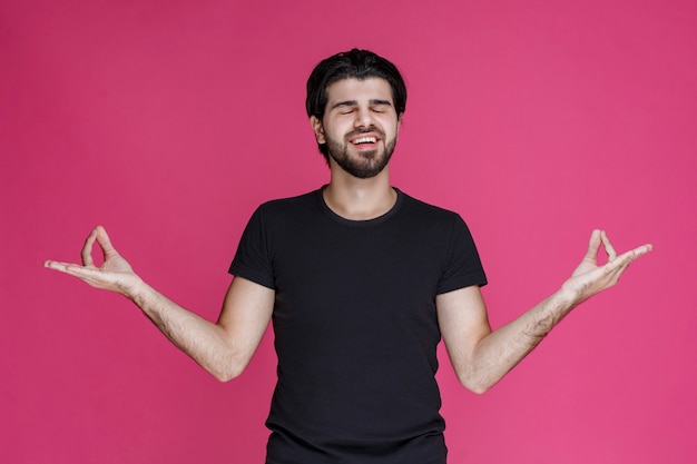 Man in black shirt feels positive about something and enjoys it