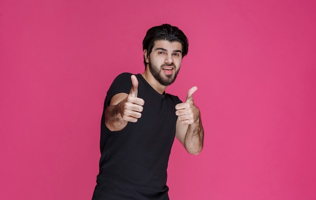 Man in black shirt feels positive about something and enjoys it