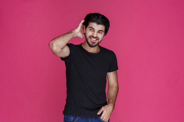 Man in black shirt feels very positive and enjoyed something