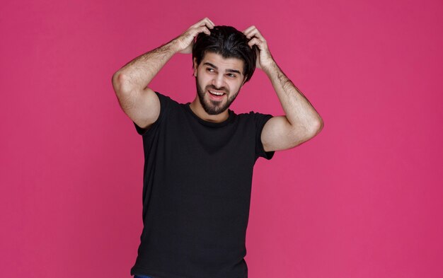 Man in black shirt feels very positive and enjoyed something