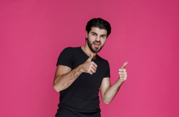 Man in black shirt feels very positive and enjoyed something