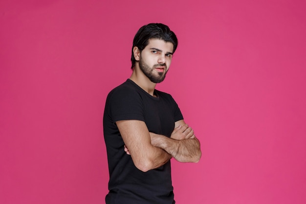 Man in black shirt looks confident and flirtatious