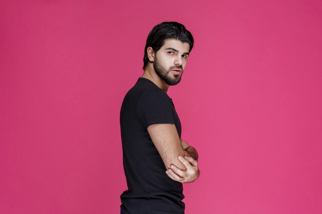 Man in black shirt looks confident and flirtatious