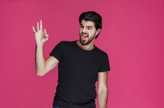 Man in black shirt shows that he is completely enjoying something