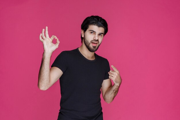 Man in black shirt shows that he is completely enjoying something