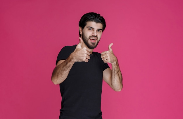 Man in black shirt shows that he is completely enjoying something