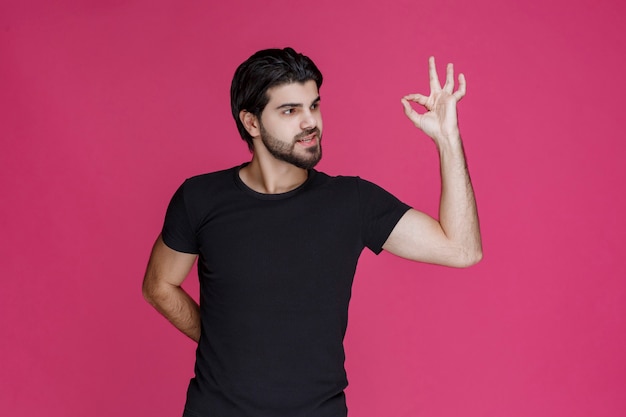 Man in black shirt shows that he is completely enjoying something