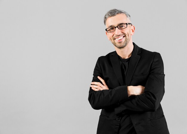 Man in black suit having his arms crossed