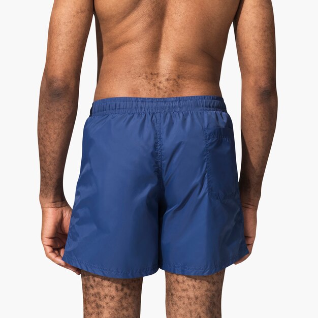 Man in a blue swim shorts back view