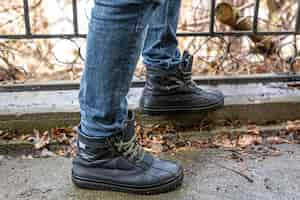 Free photo a man in boots in bad weather closeup