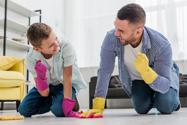 Man and boy feeling victorious while cleaning