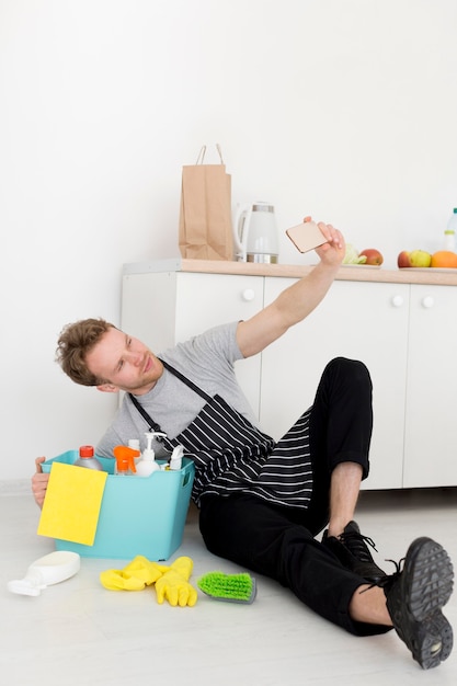 Man on break from cleaning taking selfie