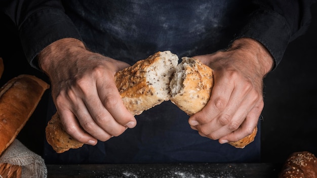 Man breaking a loaf of bread