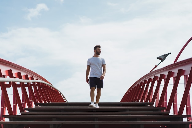 Free photo man on the bridge in amsterdam, python bridge