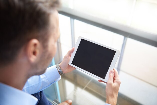 Man browsing digital tablet in the office