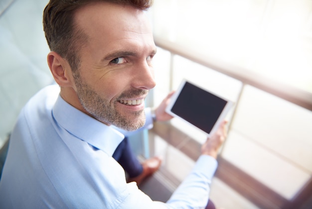 Man browsing digital tablet in the office