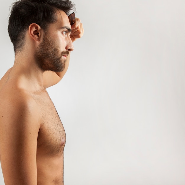 Man brushing his hair in front of the mirror