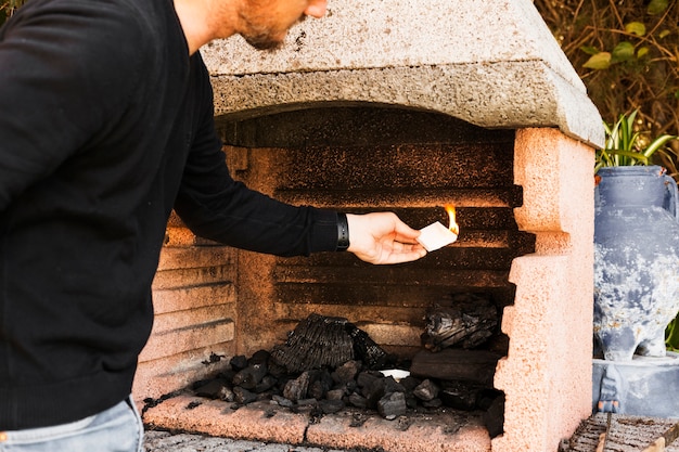 Man burning firepit with paper