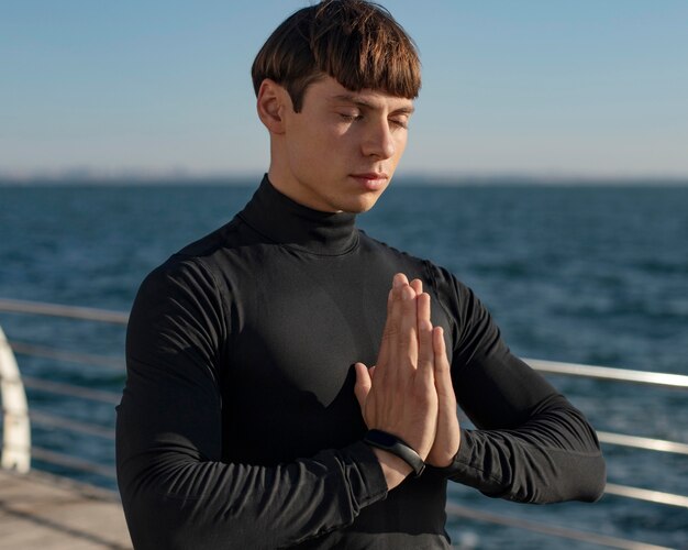 Man by the beach meditating