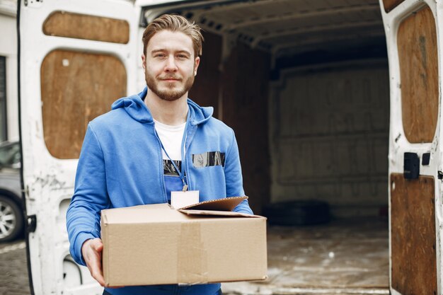 Man by the truck. Guy in a delivery uniform.