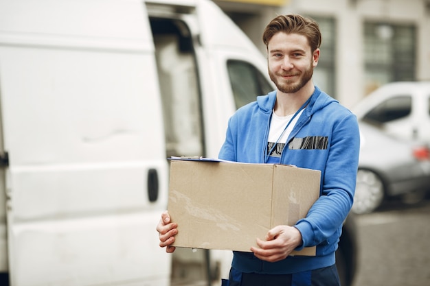 Man by the truck. Guy in a delivery uniform.