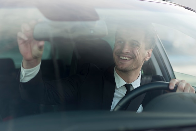 Man in car taking selfie