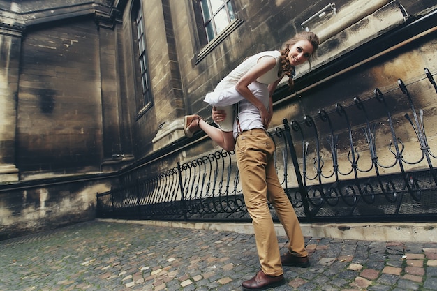 Man carries woman on his shoulder