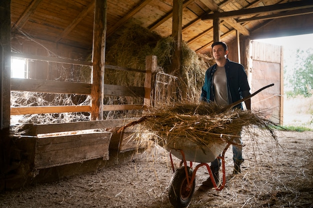 Man carrying hay full shot