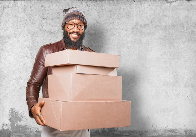 Free photo man carrying several cardboard boxes