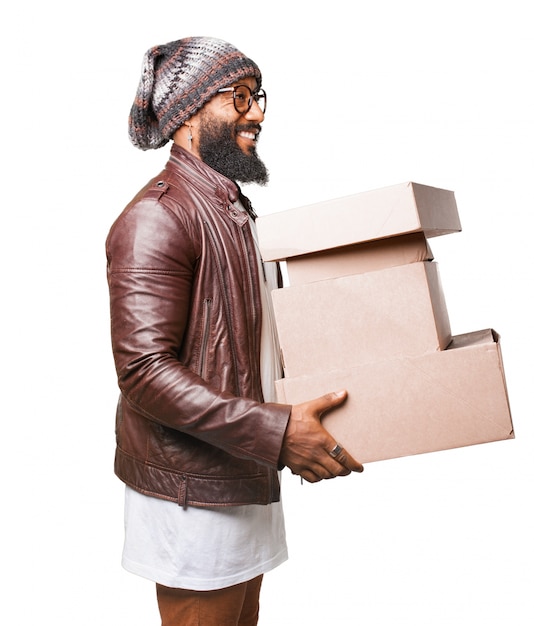 Free photo man carrying several cardboard boxes