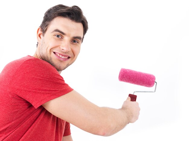 Man in casual with roller and painting wall, portrait on white