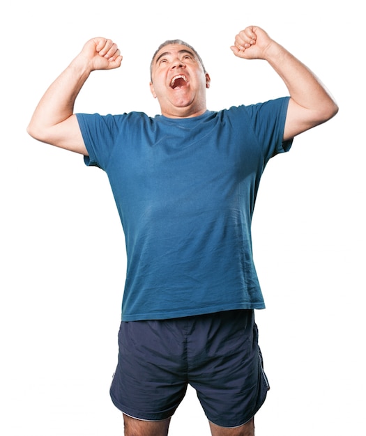 Man celebrating screaming and fists high