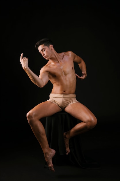 Man in chair moving flexible in dance posture