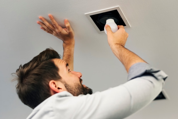 Man changing a light bulb