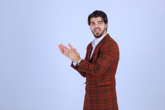 Man in checked jacket applauding something or someone. High quality photo